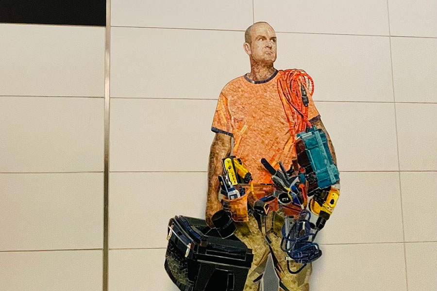 Artwork representing a contractor in a NYC subway station | Knowify