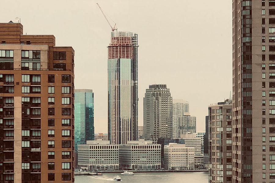 Picture of a building in construction in NJ viewed from Manhattan | Profit margin | Knowify