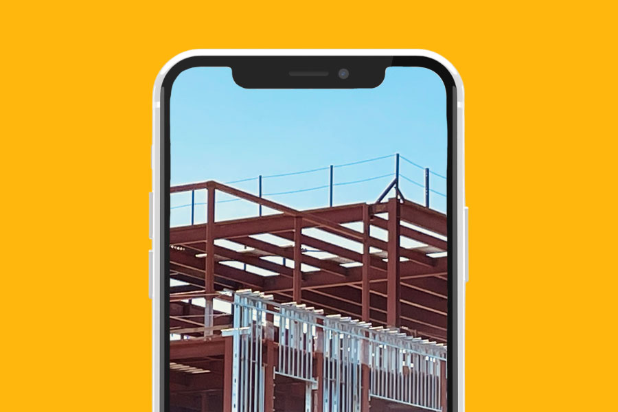 Smartphone frame with a construction site picture | Improving online presence & reputation as a contractor | Knowify