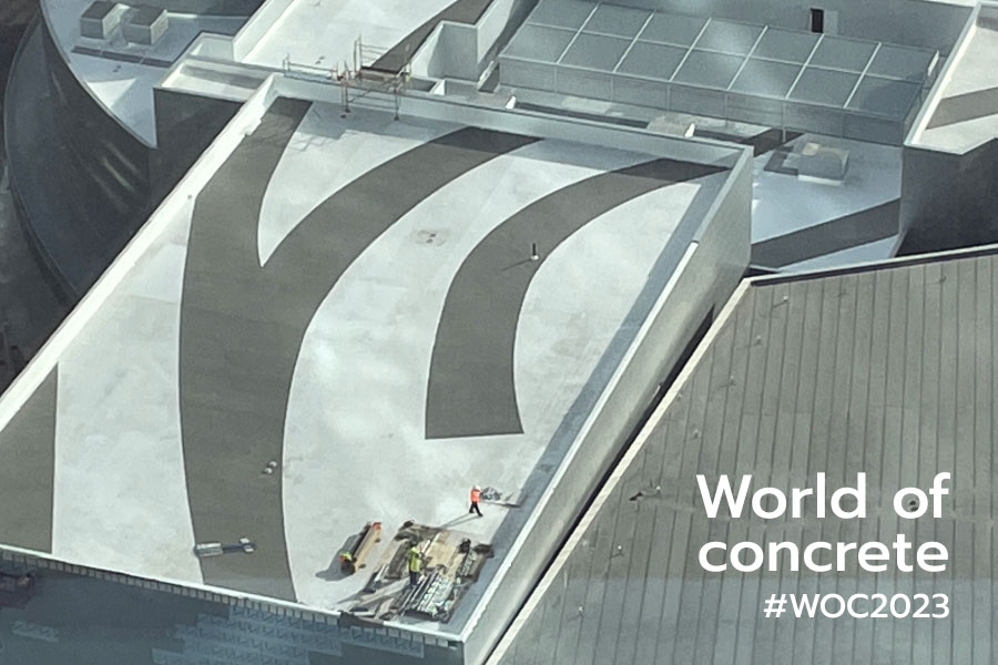 Aerial view of a construction job site with messaging reading: 'World of concrete #WOC2023' | Knowify