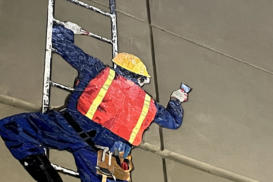 Picture of a mural depicting a contractor on a ladder (MTA subway) | Construction payroll 101 | Knowify