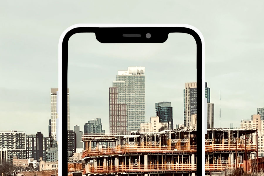 Smartphone frame overlaid on a construction site picture | 5 ways to get your team on board with new software | Knowify
