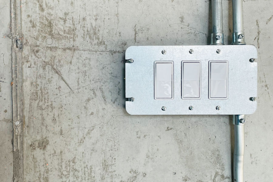 Picture of an electrical outlet installed on a concrete wall | How to bid electrical jobs | Knowify